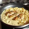 Tagliatelles crémeuses au poulet servies dans un plat gourmand et appétissant.